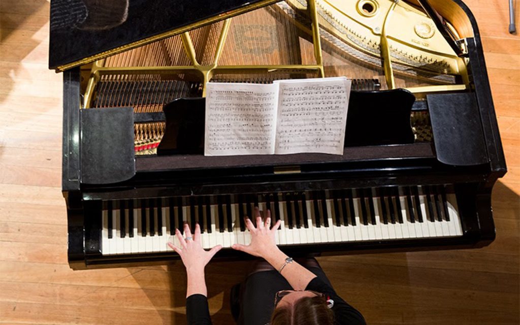 Birds eye view of a grand piano being played